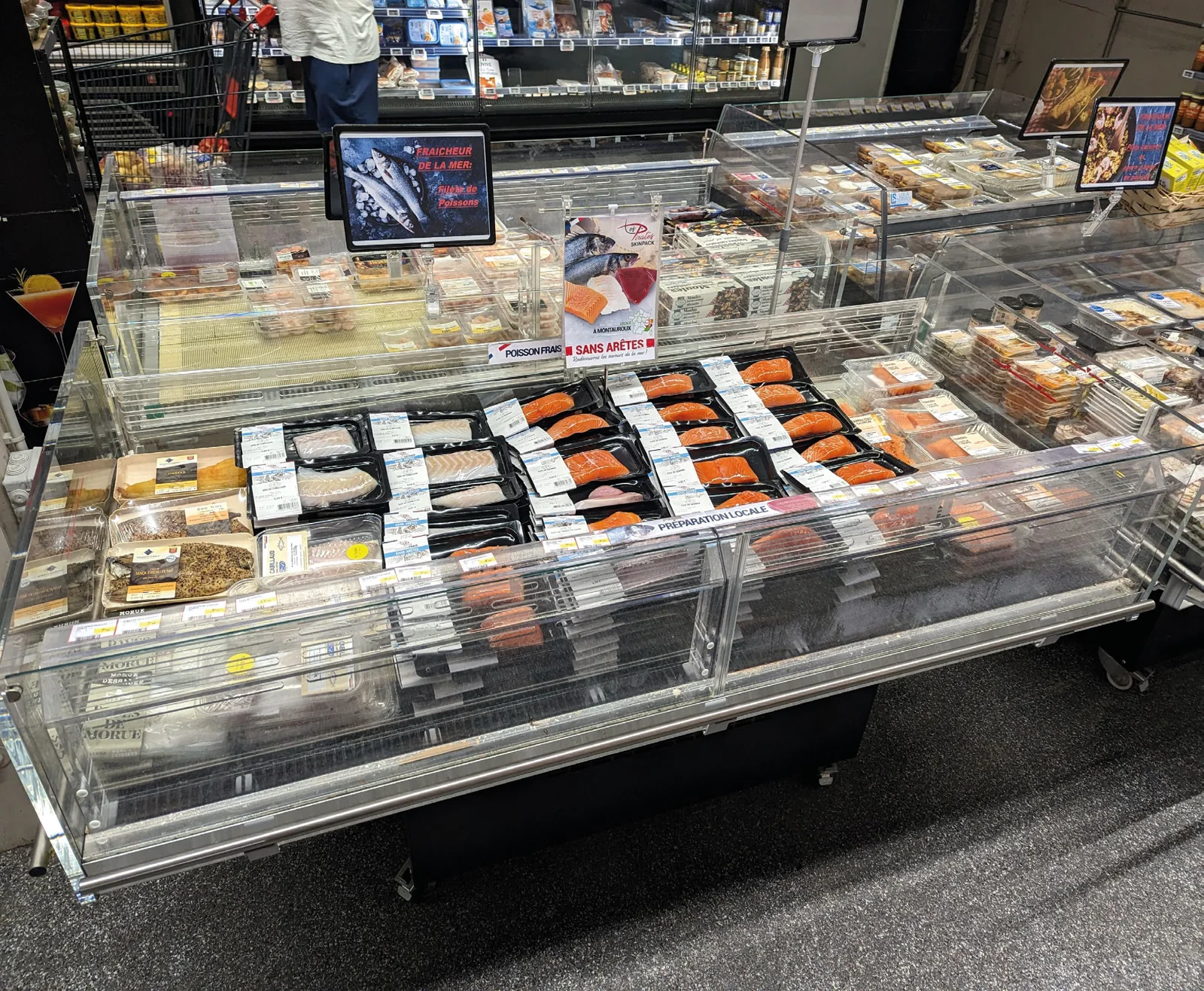 Barquettes de poissons SkinPack dans un présentoir réfrigéré de supermarché